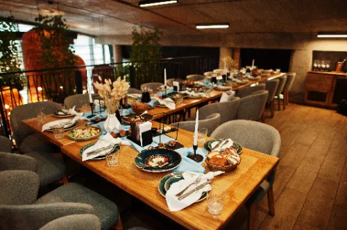 Beautifully laid tables with food, glasses and appliances in restaurant