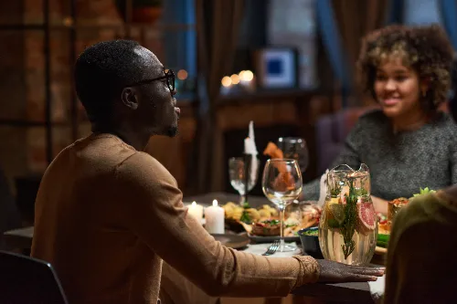 Man sitting at dining table with his friends